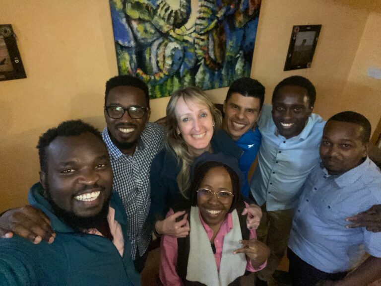Group of people smiling and posing together indoors