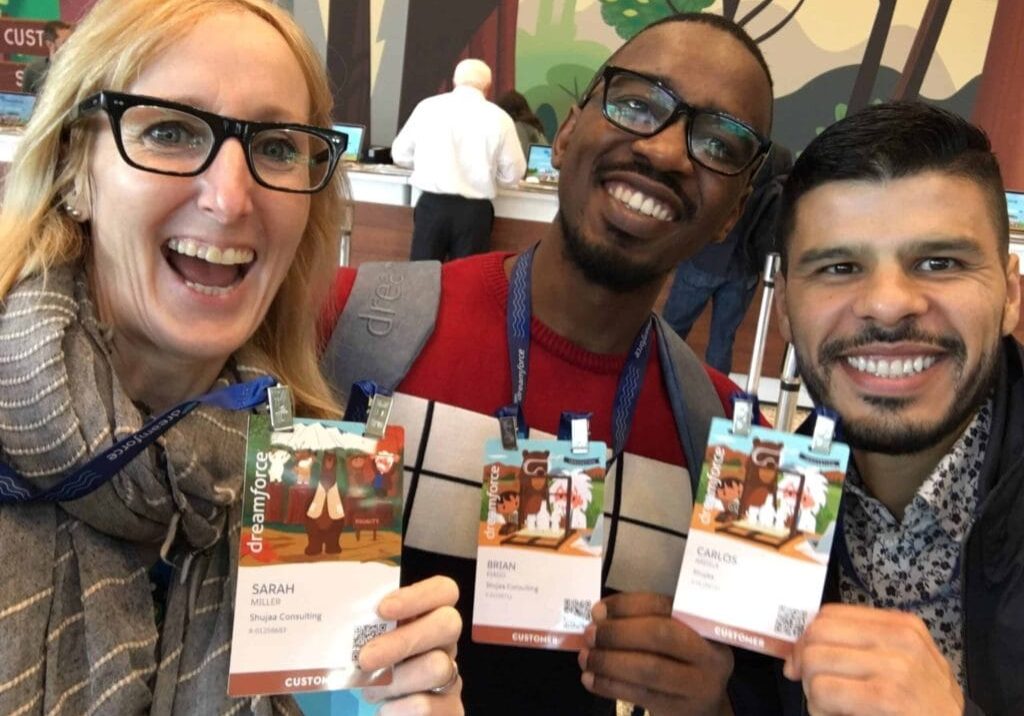 IMG-2705-scaled Three friends smiling and holding products for a photo